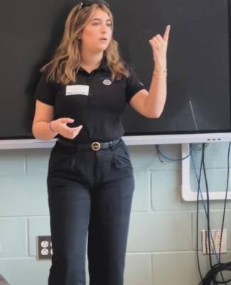 Woman giving a presentation in front of a screen